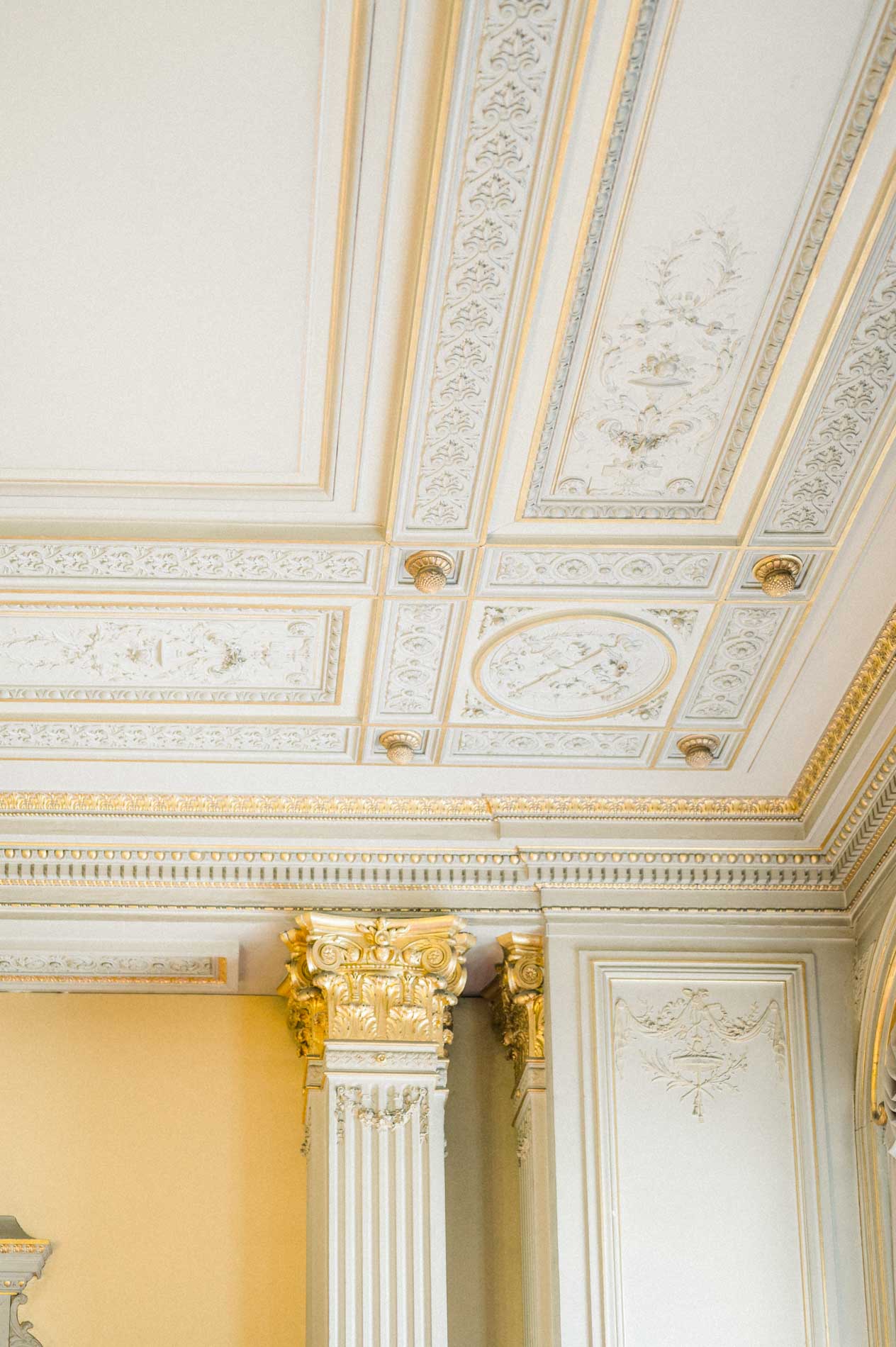 Moulded ceiling and gilded capital in the wedding hall