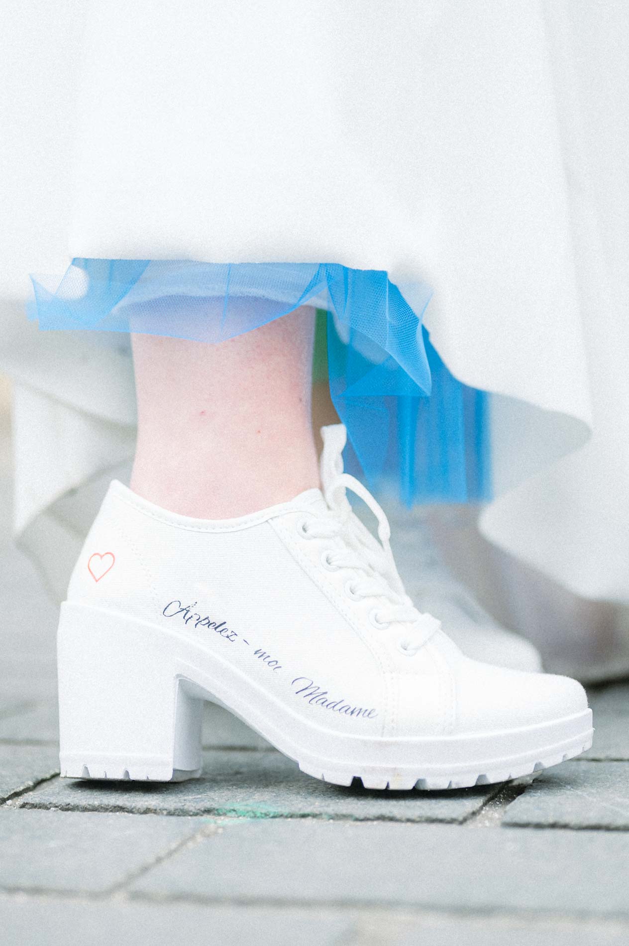 Bride's white platform boots beneath her dress