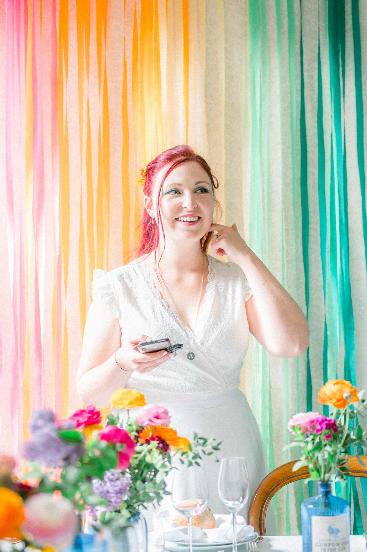 Dreamy bride in front of the rainbow ribbon backdrop