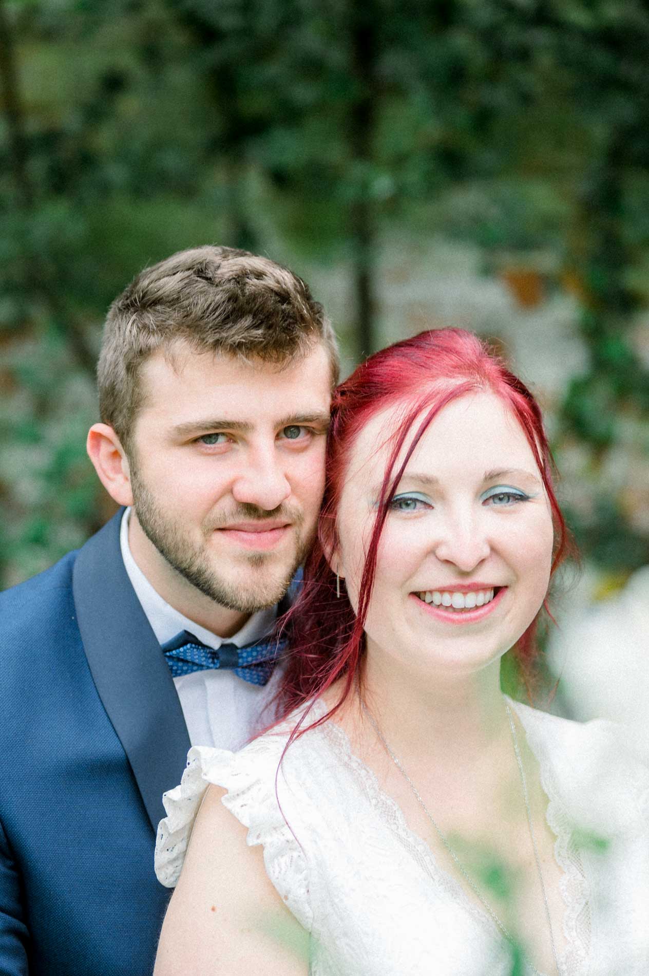 Cheek-to-cheek portrait of Tiffa and Geo among the greenery