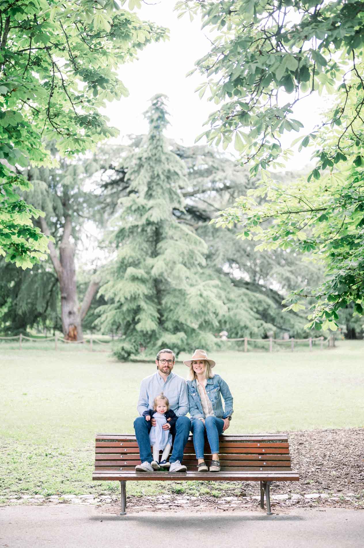 The family sitting on a bench in a clearing of Parc Bordelais