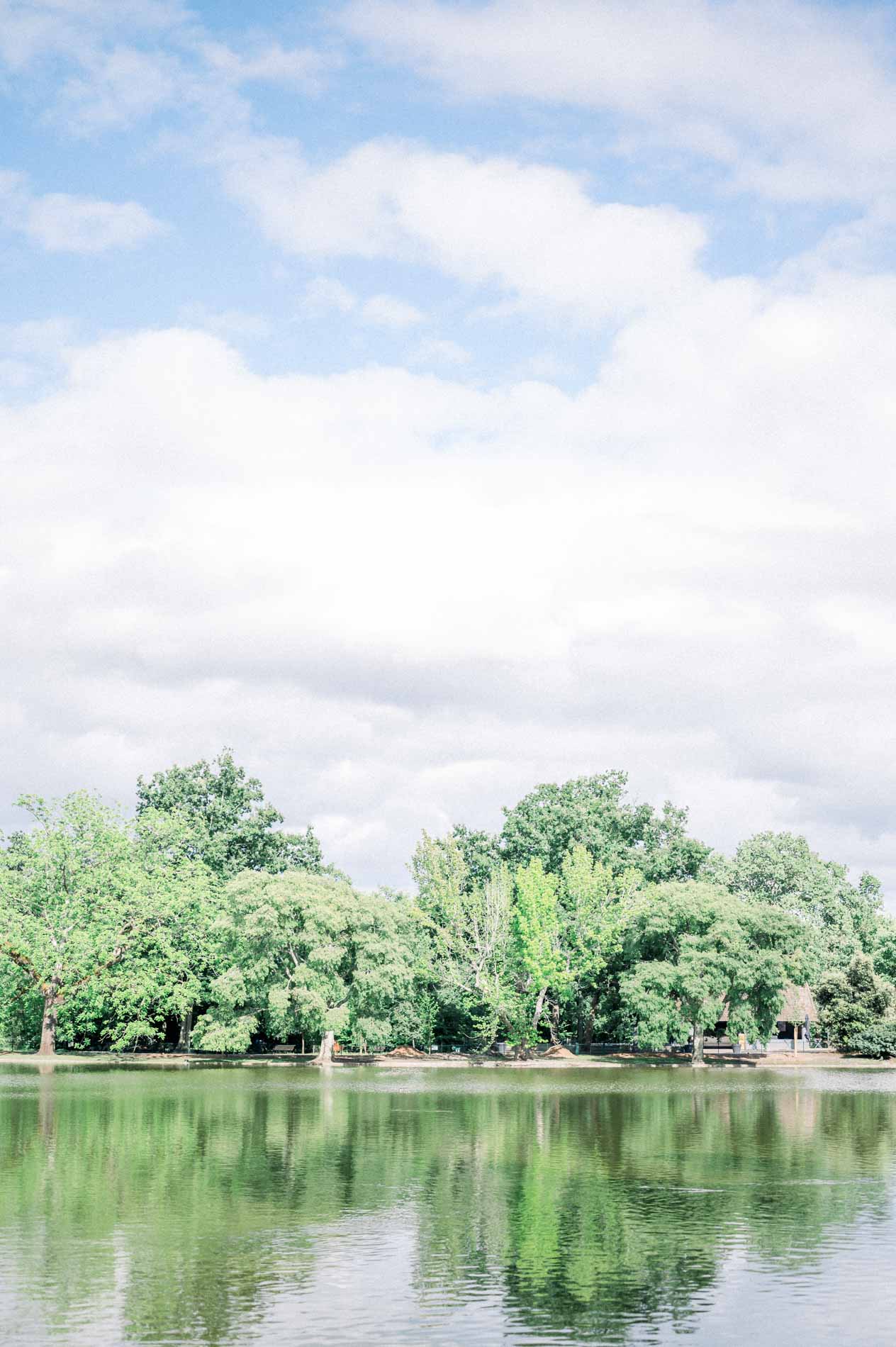 The Parc Bordelais lake reflecting the trees and clouds