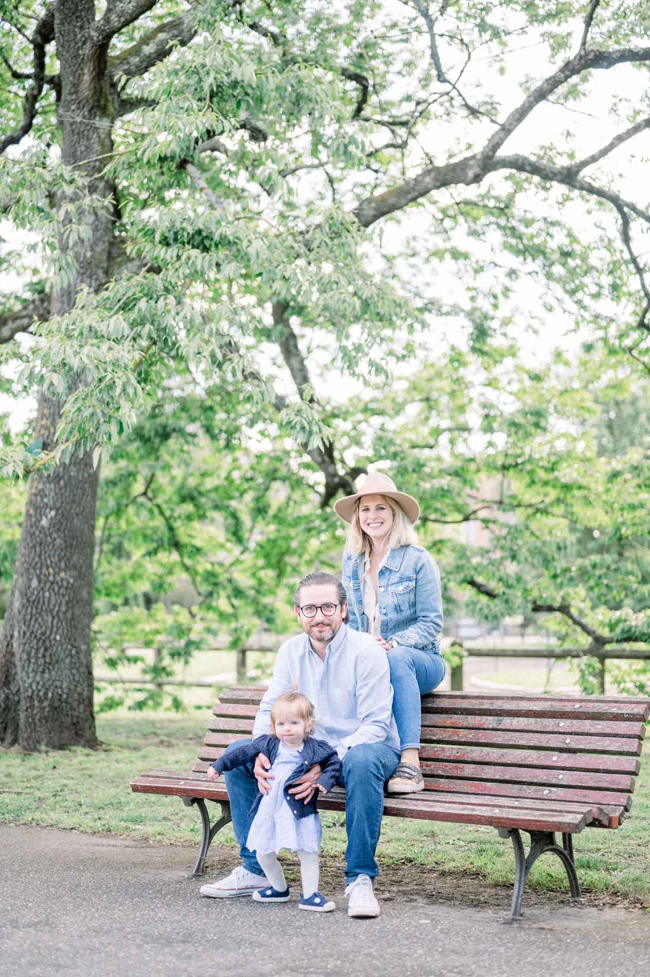 The family gathered on a bench beneath a large tree in Parc Bordelais