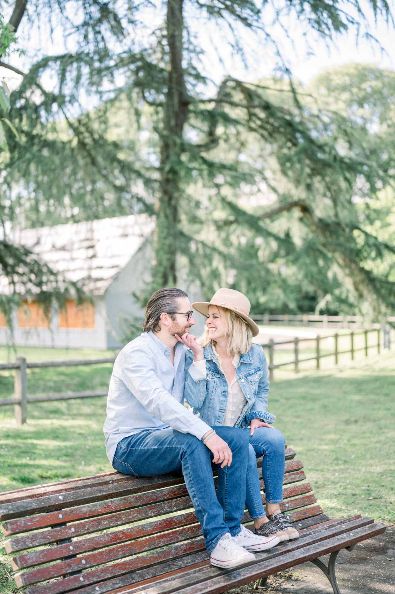 The parents gazing at each other, sitting on top of the bench
