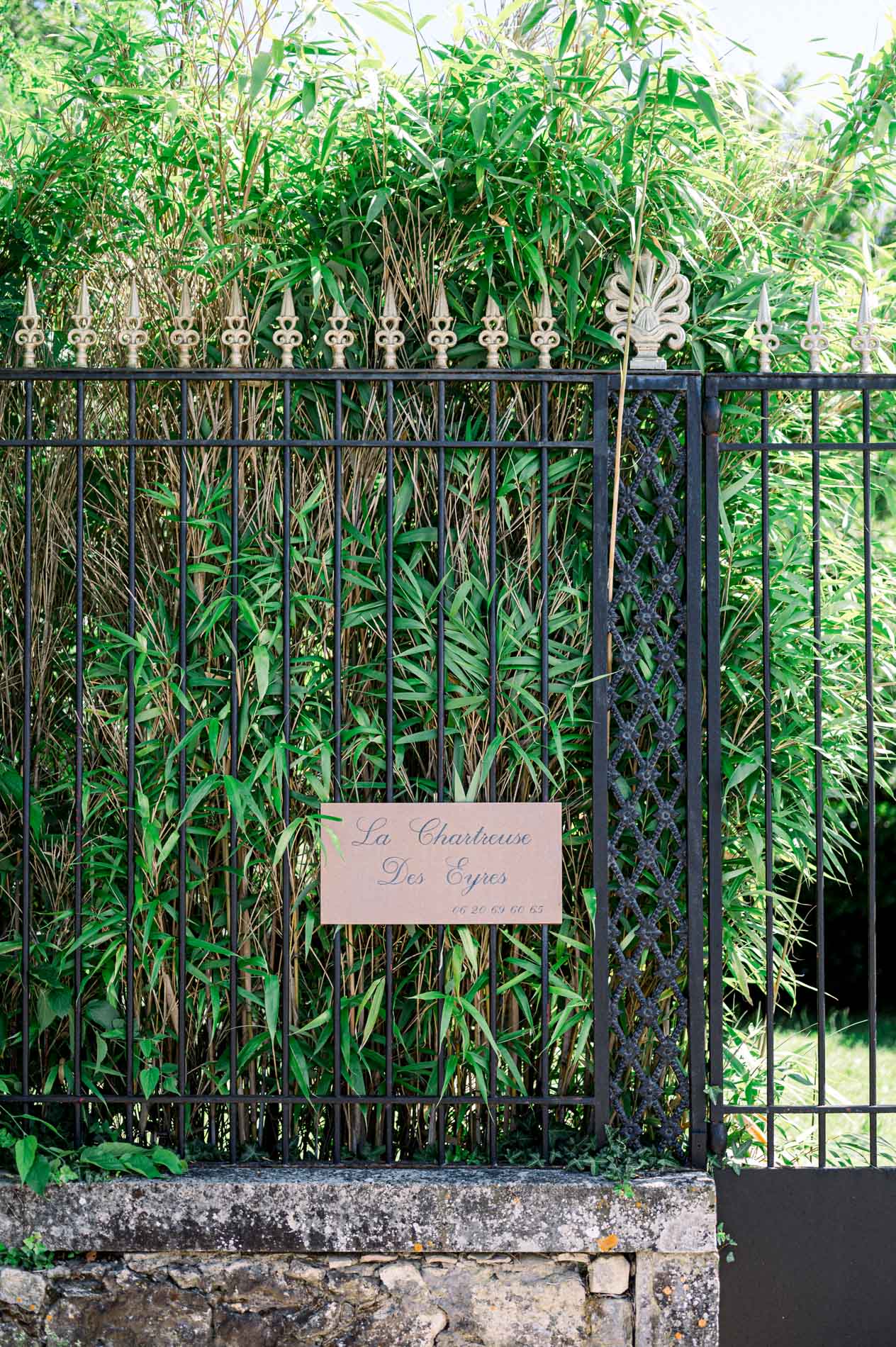 Black wrought-iron gate and entrance sign of the Chartreuse des Eyres