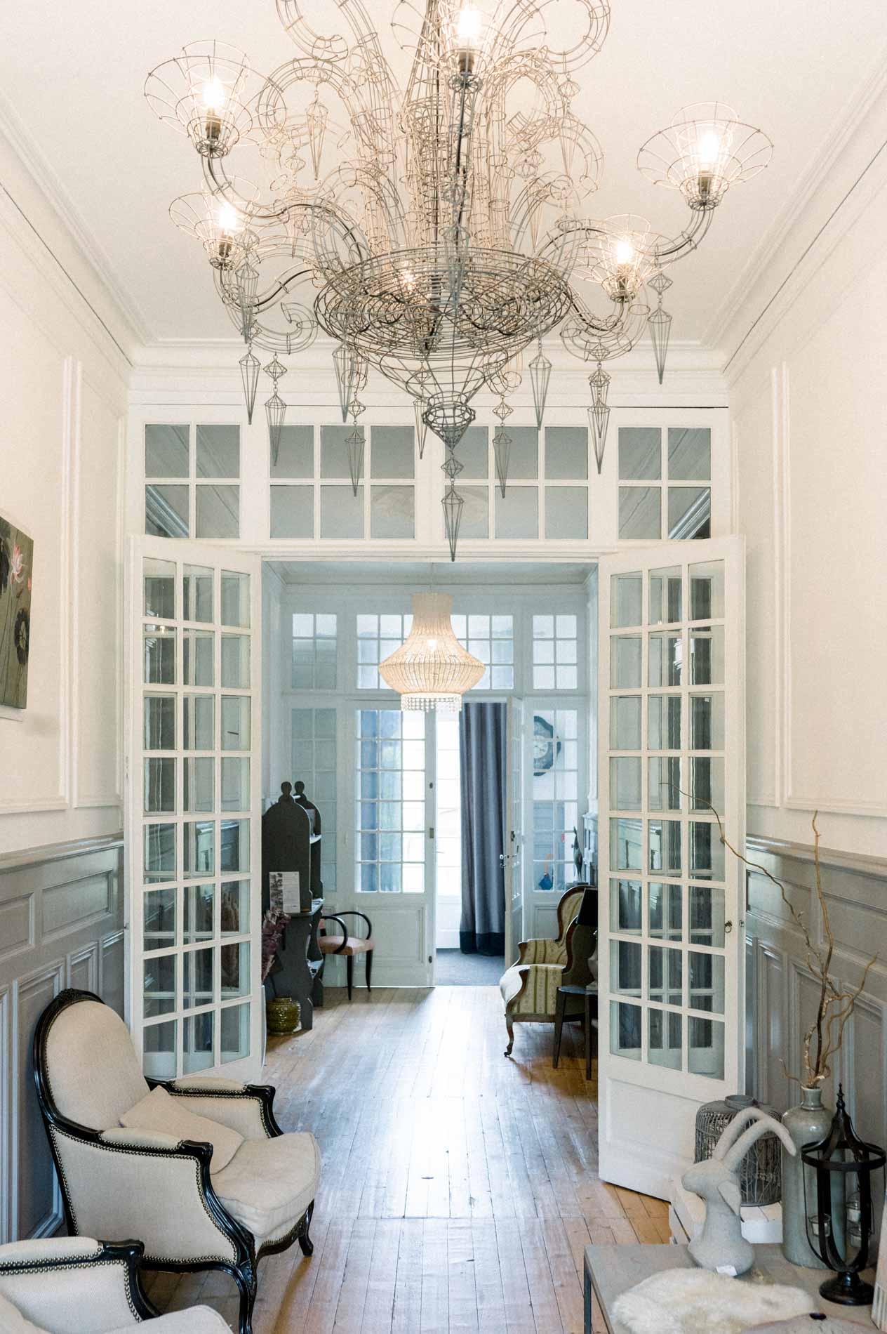 Upstairs entrance with crystal chandelier and glazed doors at the Chartreuse