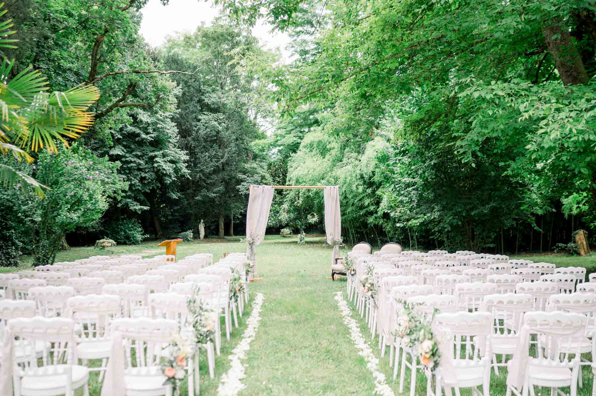 Rows of white chairs for the outdoor ceremony in the Chartreuse des Eyres grounds