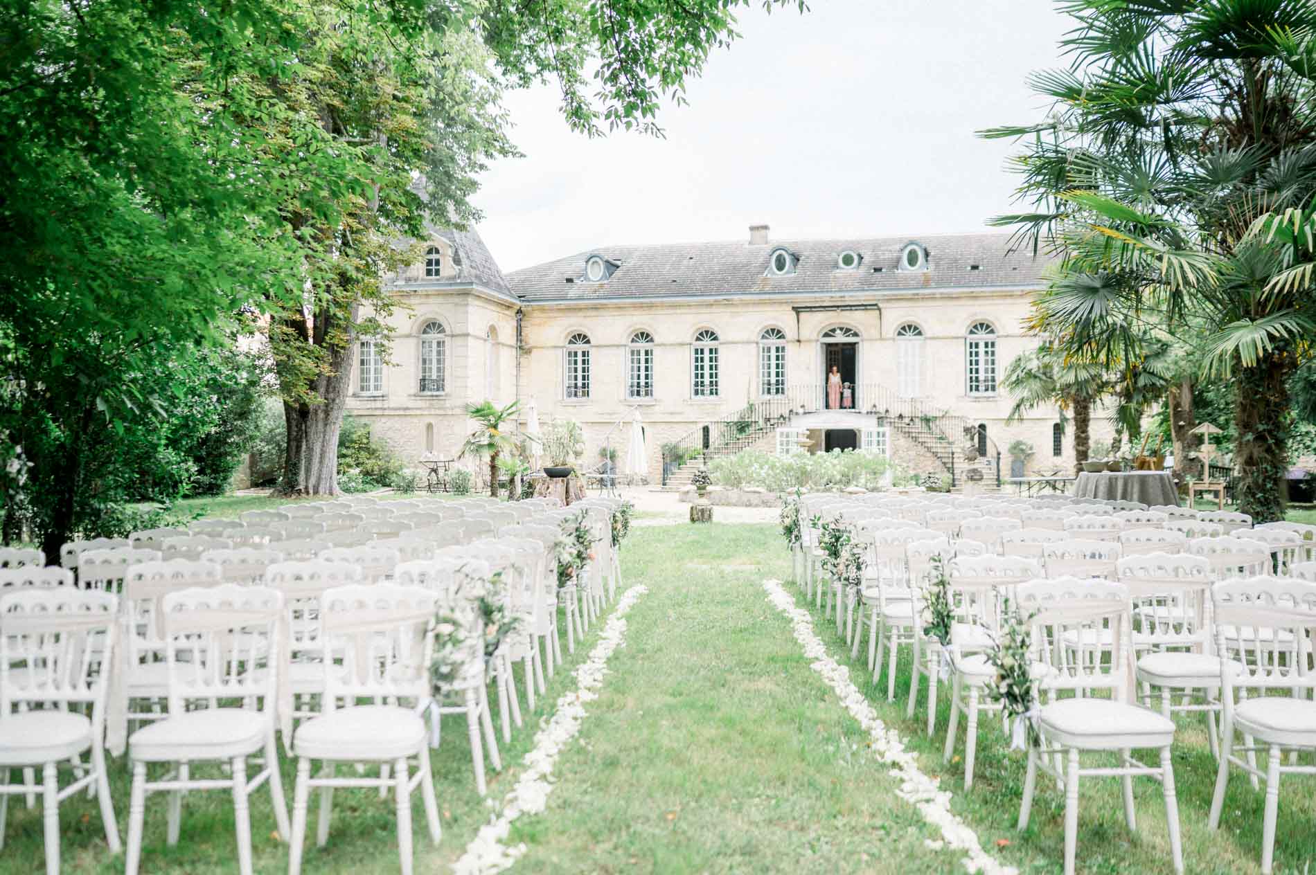 Outdoor ceremony set up on the lawn facing the Chartreuse facade