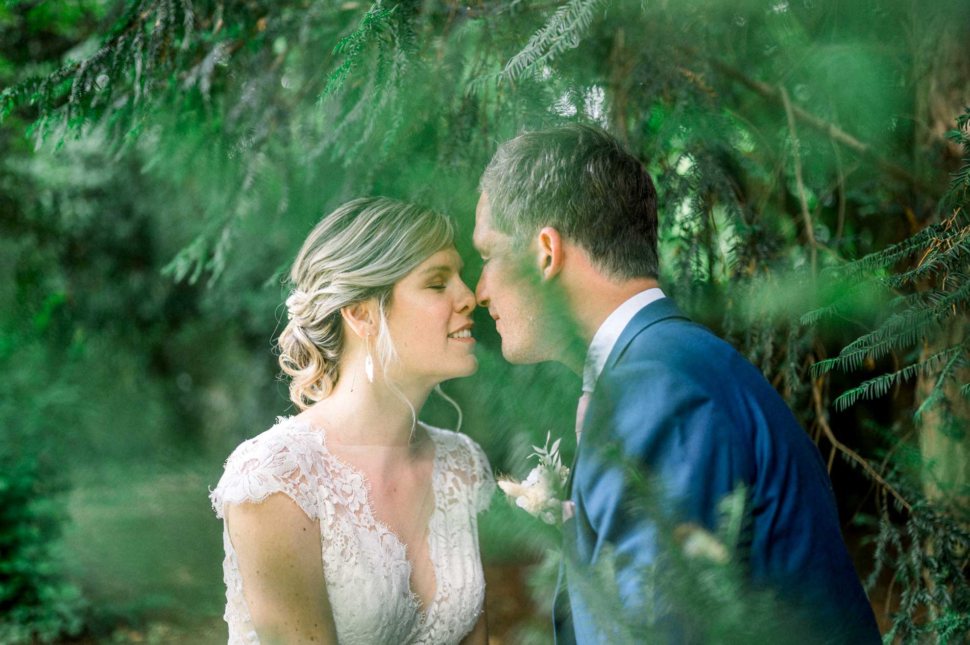 Emilie and Aurelien forehead to forehead among the greenery at Chartreuse des Eyres