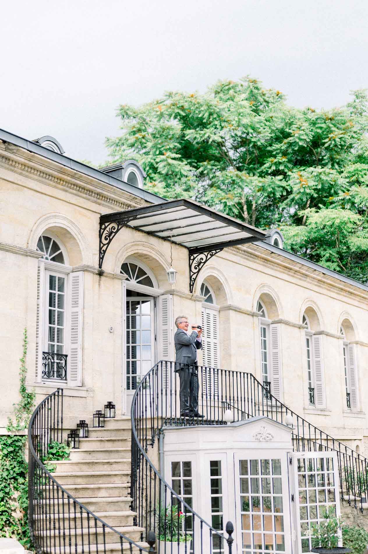 Guest taking photos from the outdoor staircase of the Chartreuse des Eyres