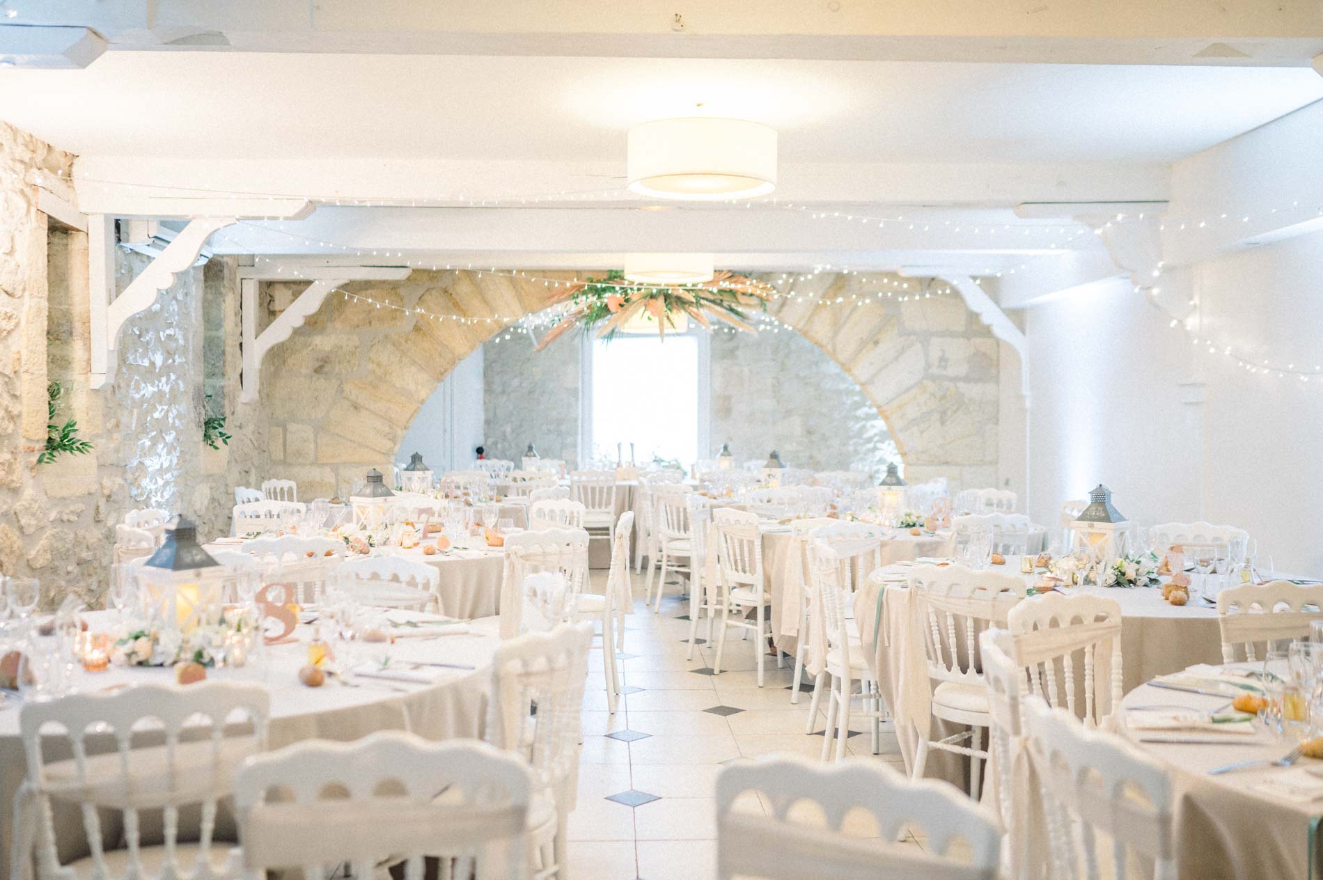 Vaulted stone reception room set for the wedding dinner
