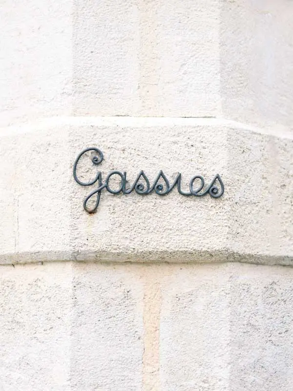 "Gassies" spelled in wrought iron letters on the château's stone wall