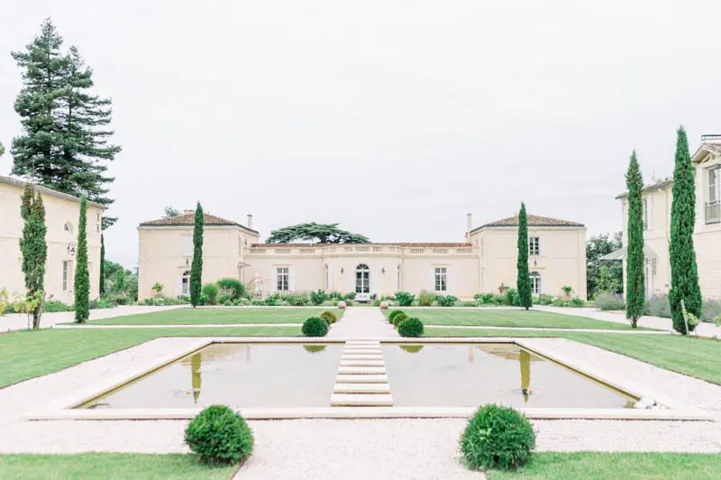 Rectangular reflecting pool and formal garden in front of Château Gassies