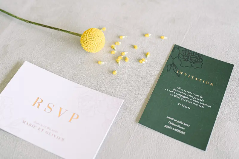 RSVP card and dark green invitation with gold lettering and billy buttons