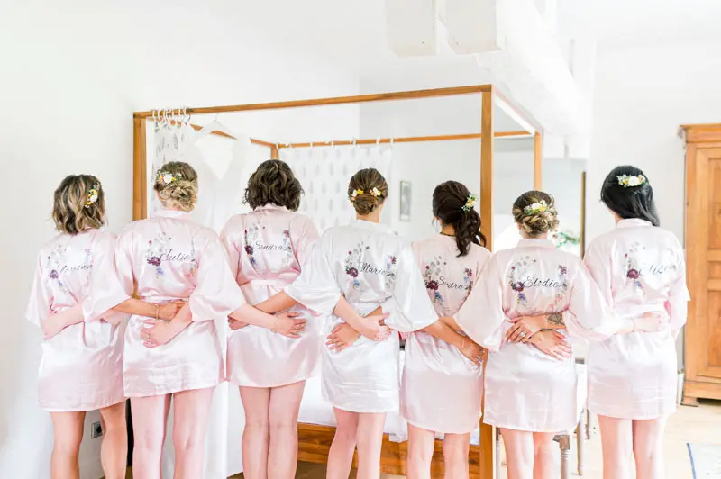 Bridesmaids seen from behind showing their personalised robes
