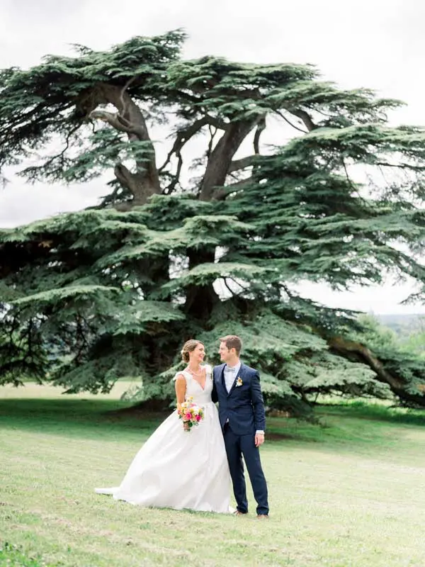 Bride and groom embracing beneath the great cedar of Lebanon in the grounds