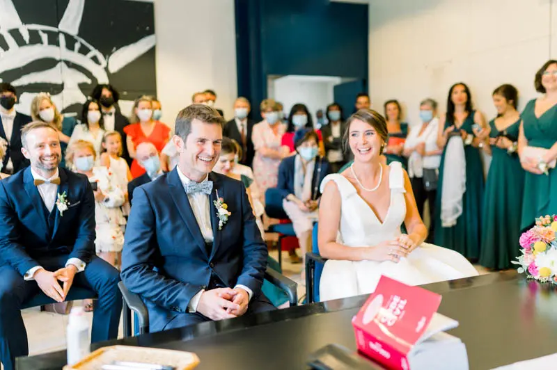 Bride and groom seated during the civil ceremony at Bouliac town hall