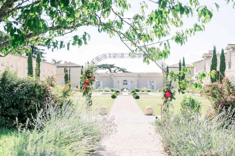 Flower-lined path edged with lavender leading into the Château Gassies garden