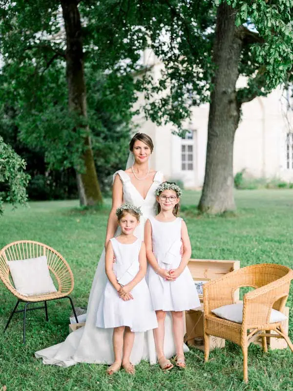 Portrait of the bride with two young flower girls at Château Gassies