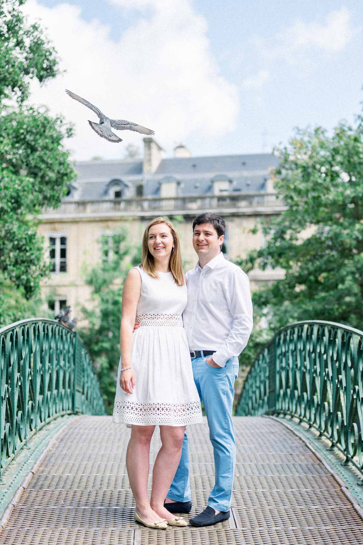 Tamara and Nicolas on a footbridge in the Jardin Public in Bordeaux, a pigeon in flight