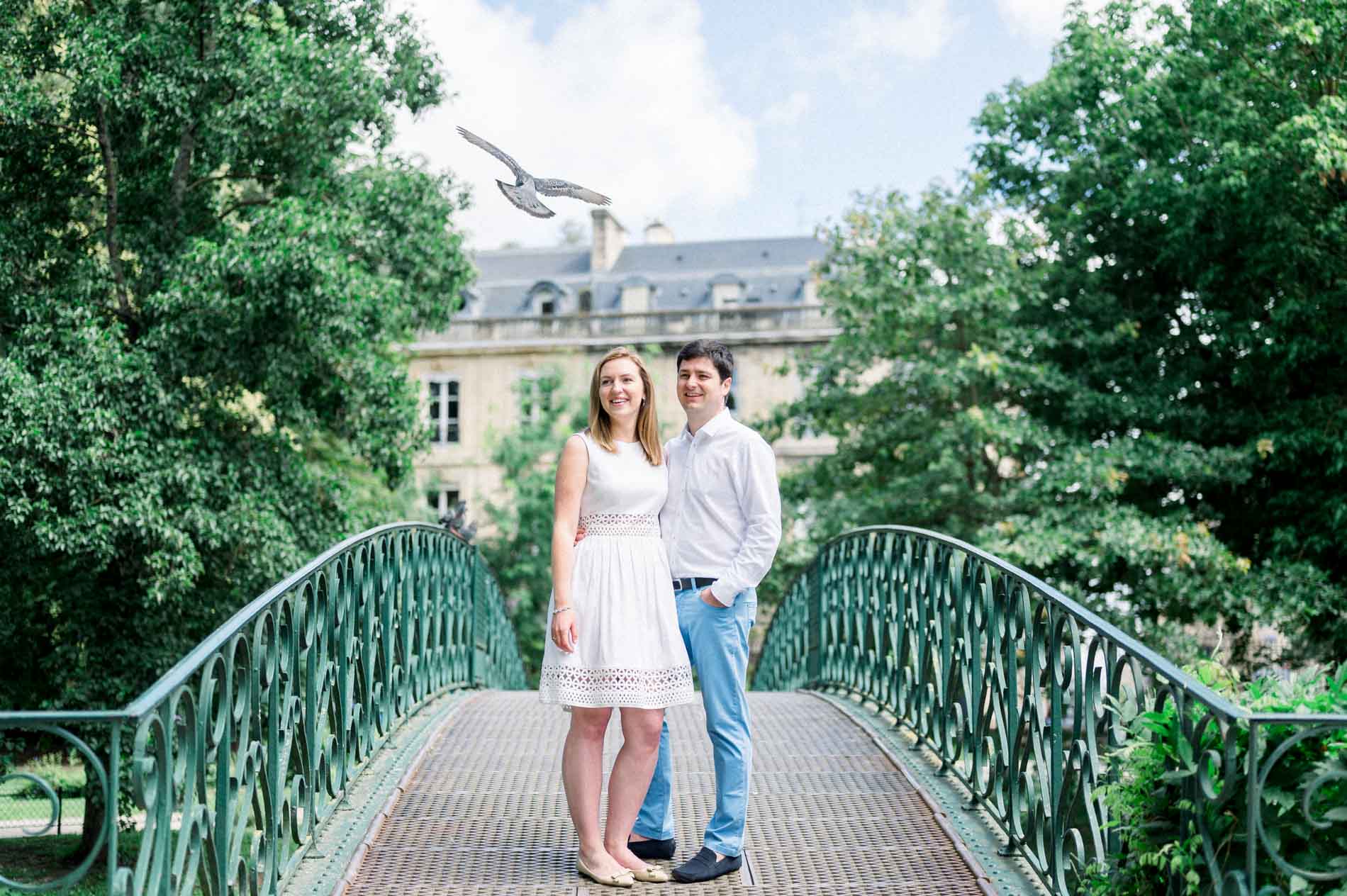 Tamara and Nicolas on a footbridge in the Jardin Public in Bordeaux, a pigeon in flight