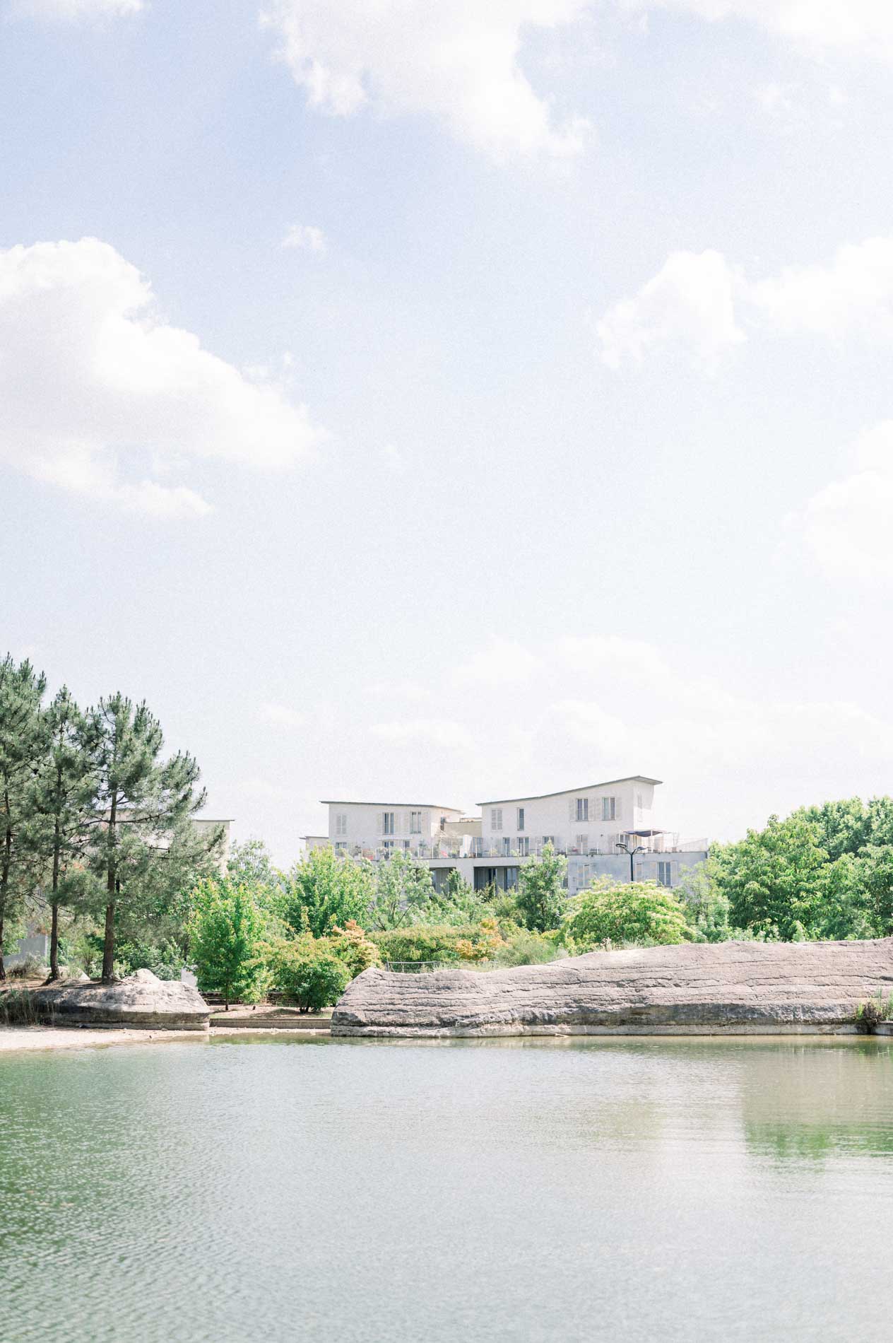 Pond and rocks at the Bordeaux botanical garden under a cloudy sky