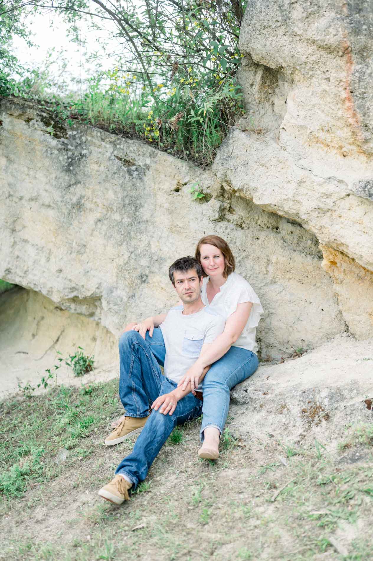 The parents sitting against a rocky outcrop in the botanical garden