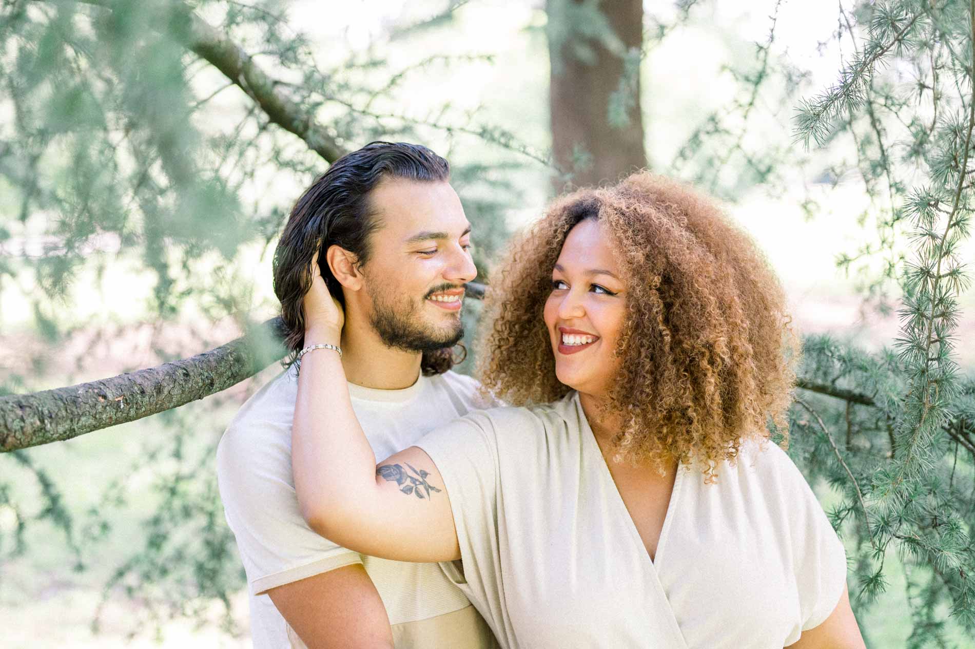 Couple laughing, her hand running through her partner's hair
