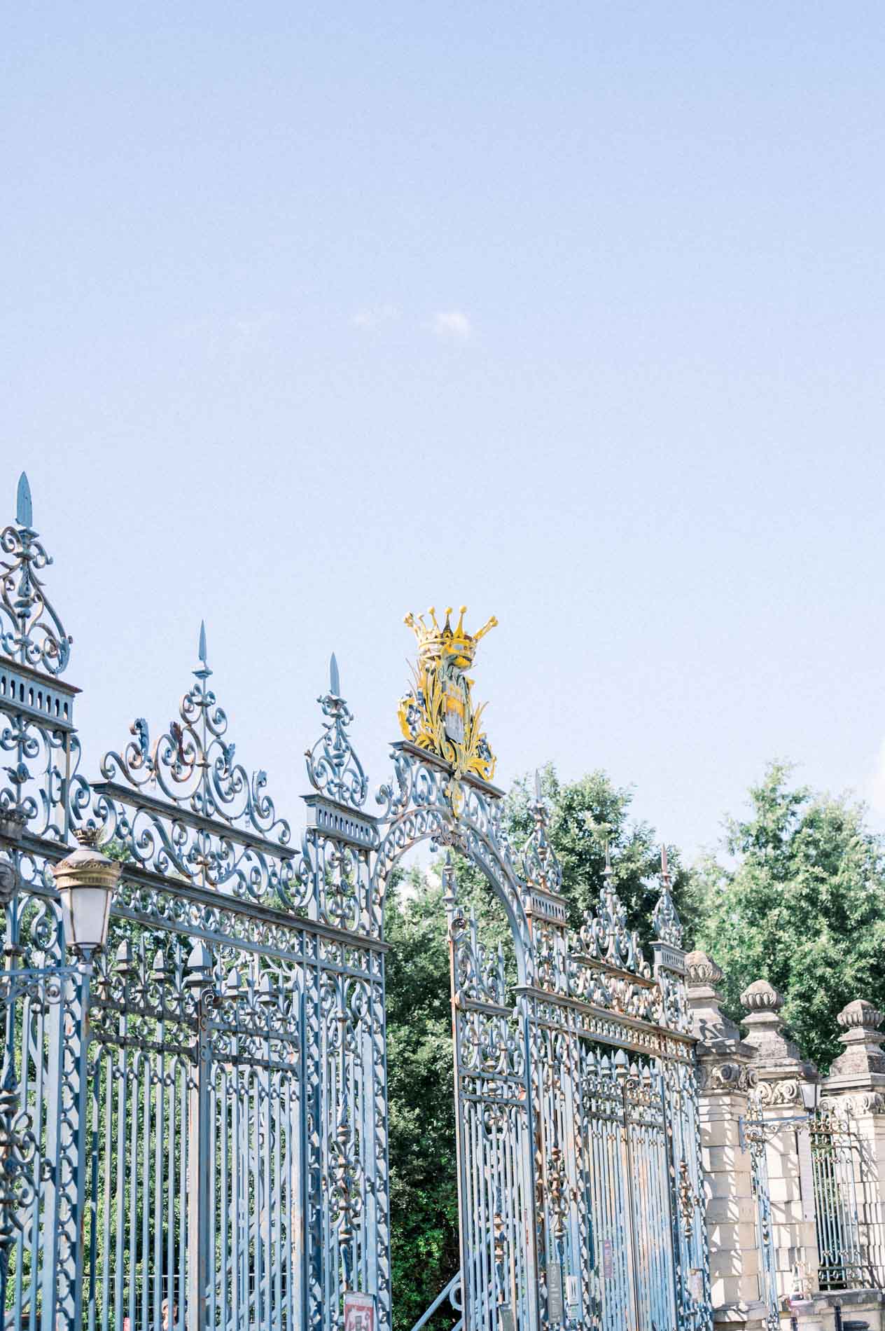 Ornate gilded wrought-iron gate at the entrance of the Parc Bordelais