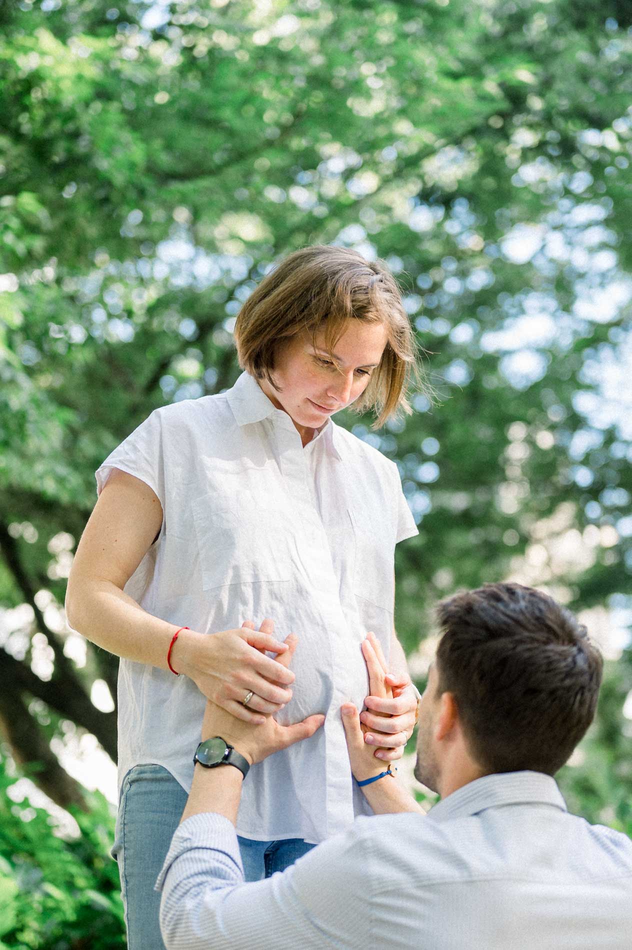 Father-to-be placing his hands on his pregnant partner's belly