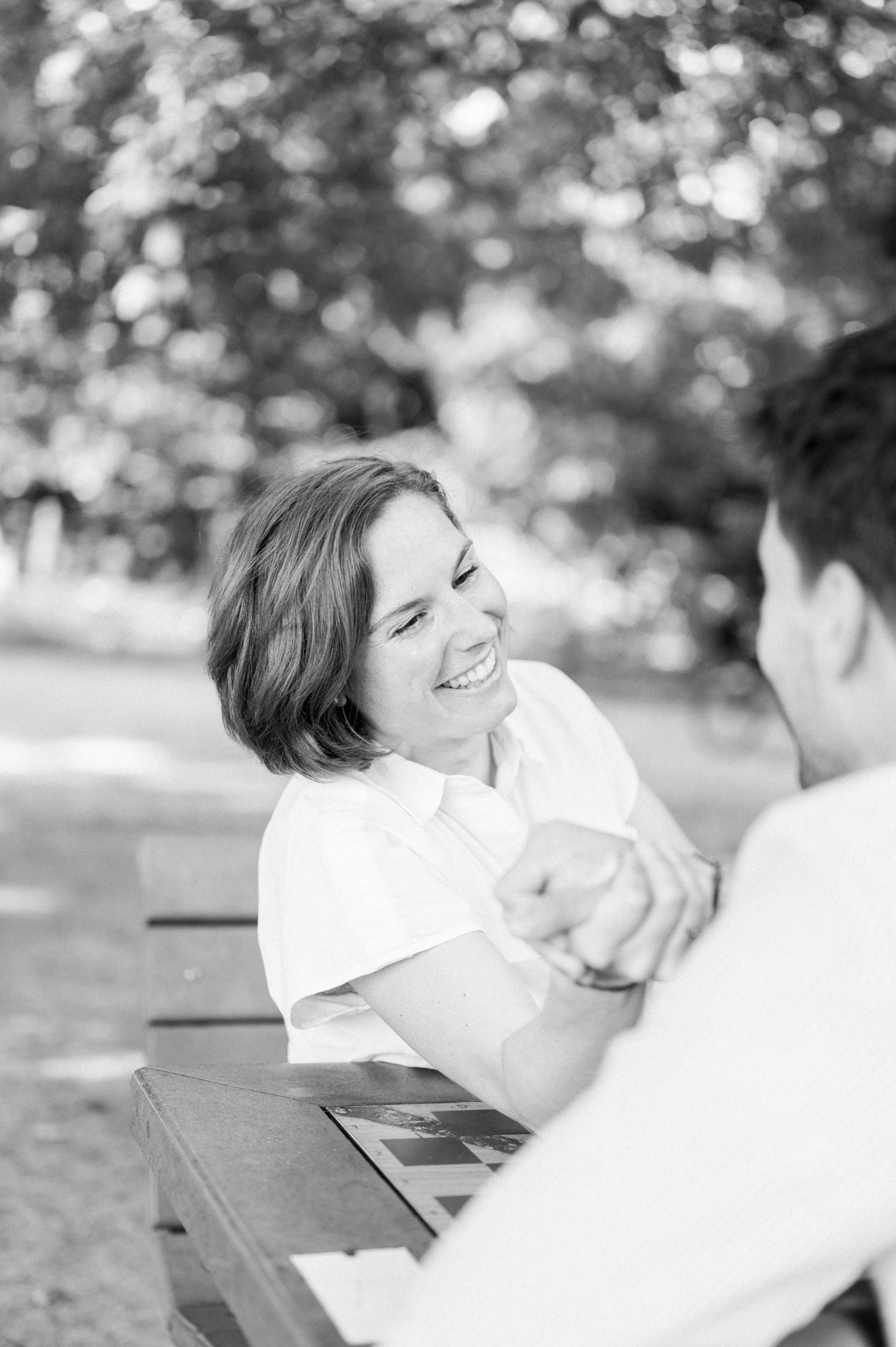 Mother-to-be laughing during the arm wrestle, in black and white
