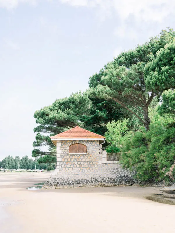 Small stone beach house on the sand beneath the pines at Villa la Tosca