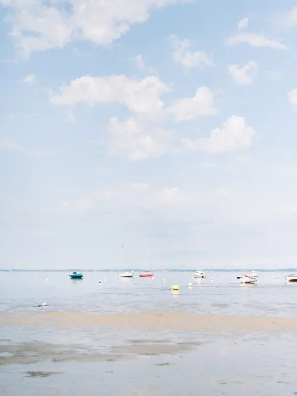 Arcachon Bay at low tide with boats moored in the distance