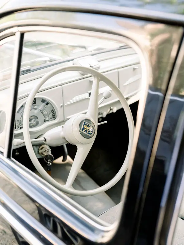 White steering wheel and dashboard of the vintage wedding car