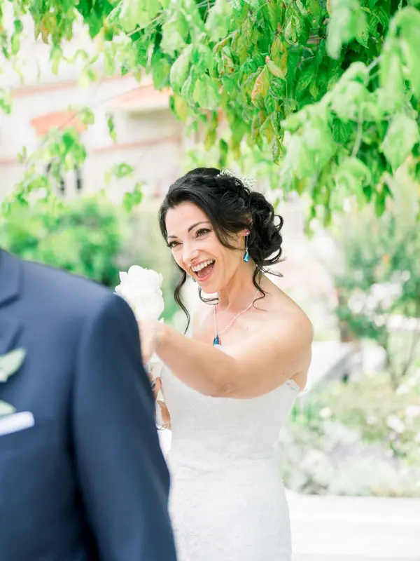 The bride beaming as she sees the groom during the first look