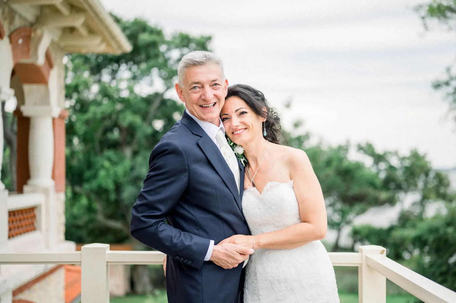 The bride and groom embracing on the terrace of Villa la Tosca in Lanton