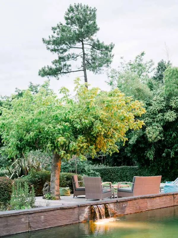 Sunset light over the garden and outdoor lounge of Villa la Tosca