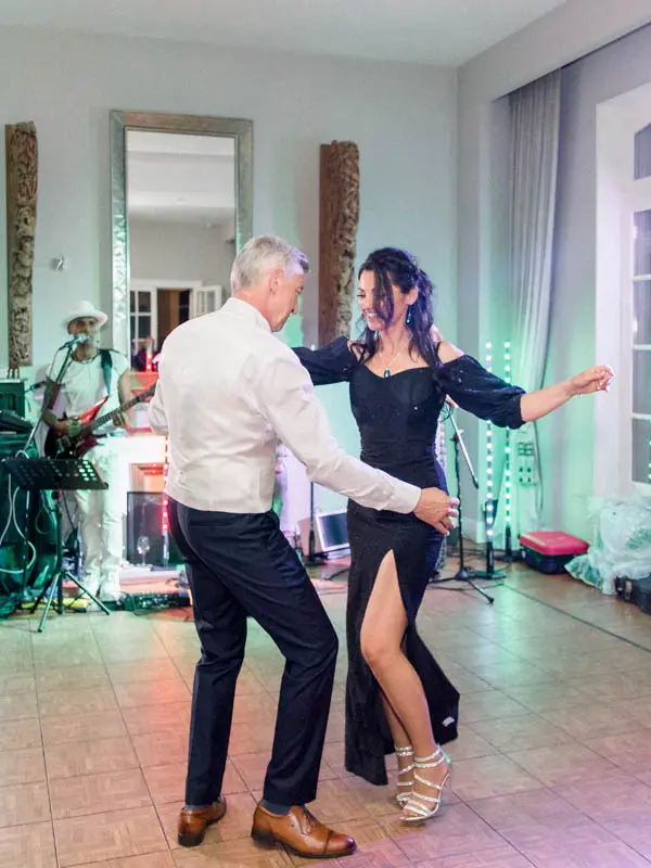 The bride and groom sharing their first dance in front of the band