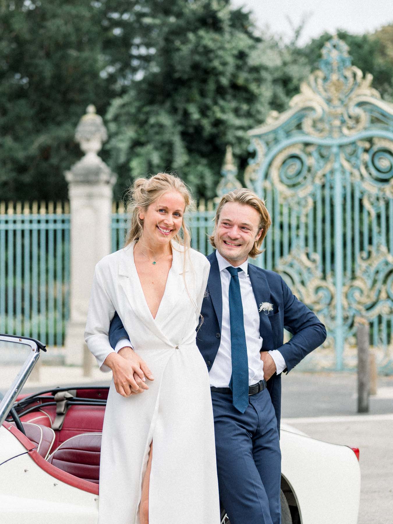 The couple leaning on their vintage convertible by the Parc de Bagatelle gates