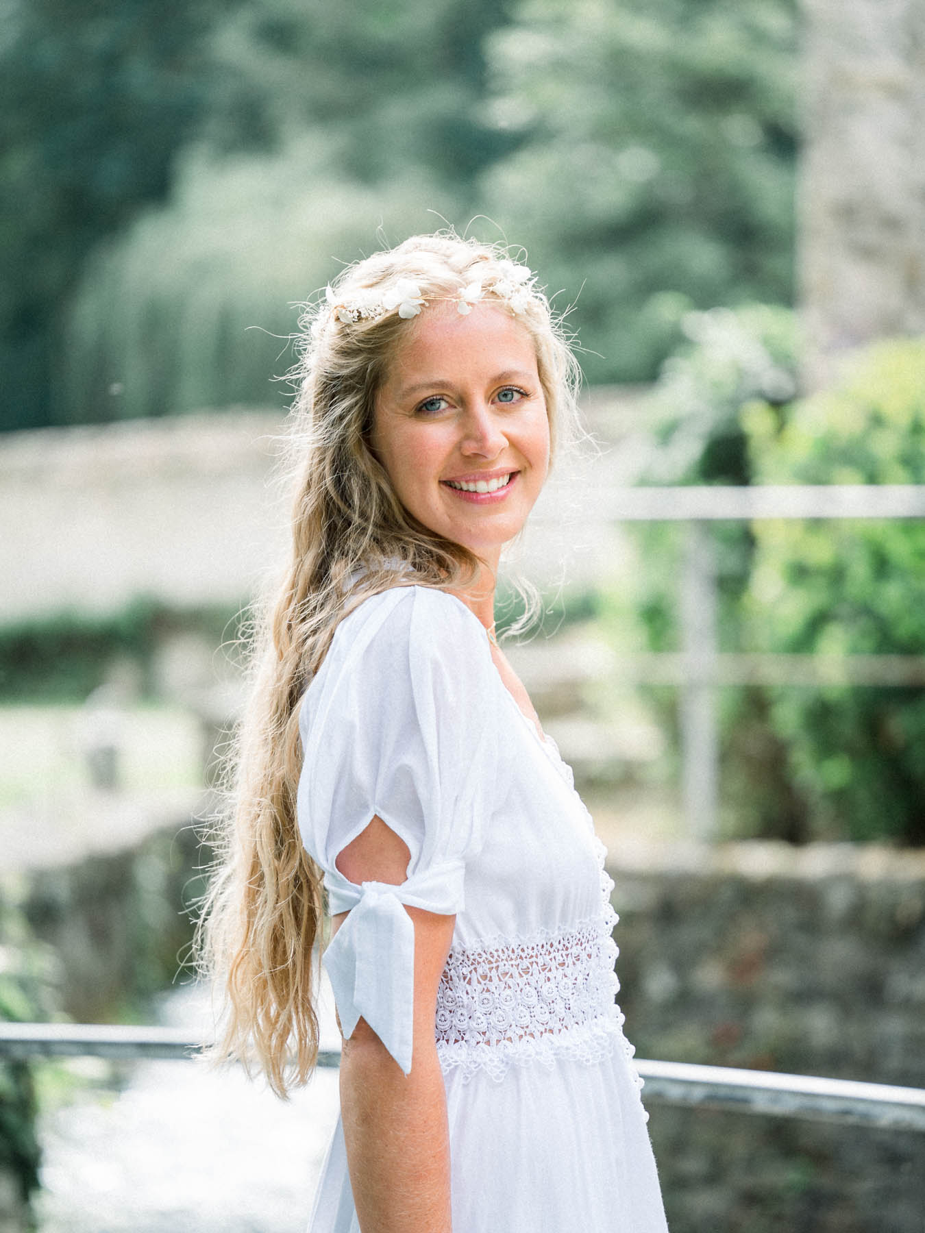 Portrait of the smiling bride wearing a flower crown