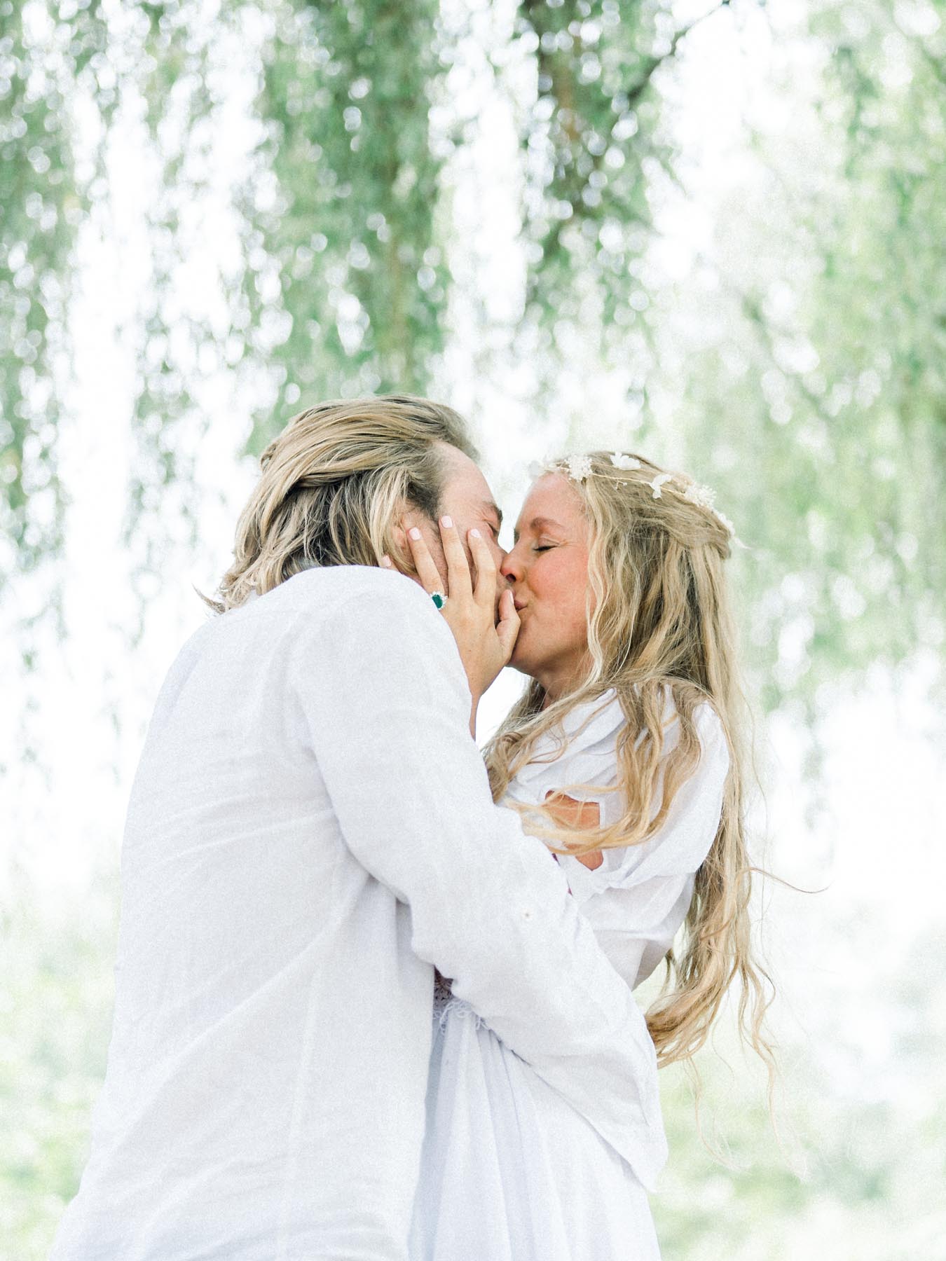 The couple kissing beneath the curtain of weeping willows the day after