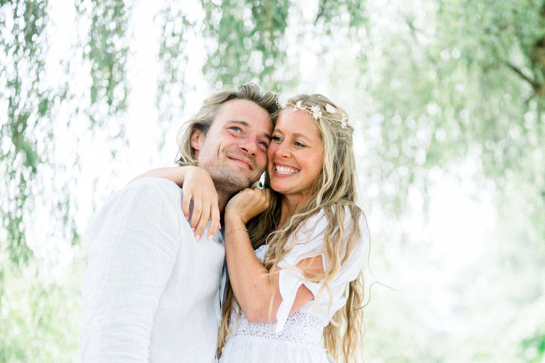 Bride and groom laughing cheek to cheek at Moulin de Launoy