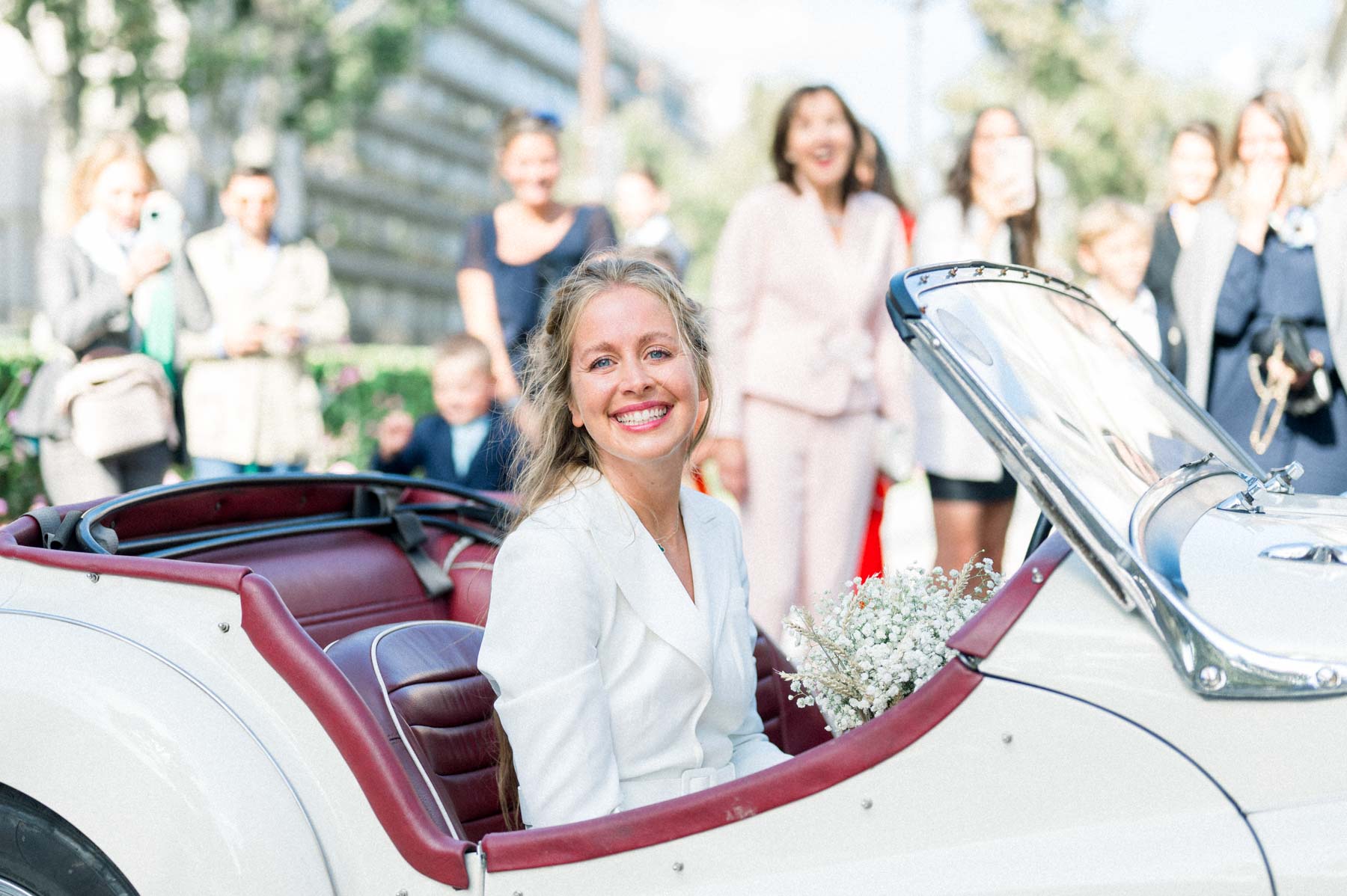 The bride arrives in a vintage convertible at Neuilly-sur-Seine town hall, greeted by guests
