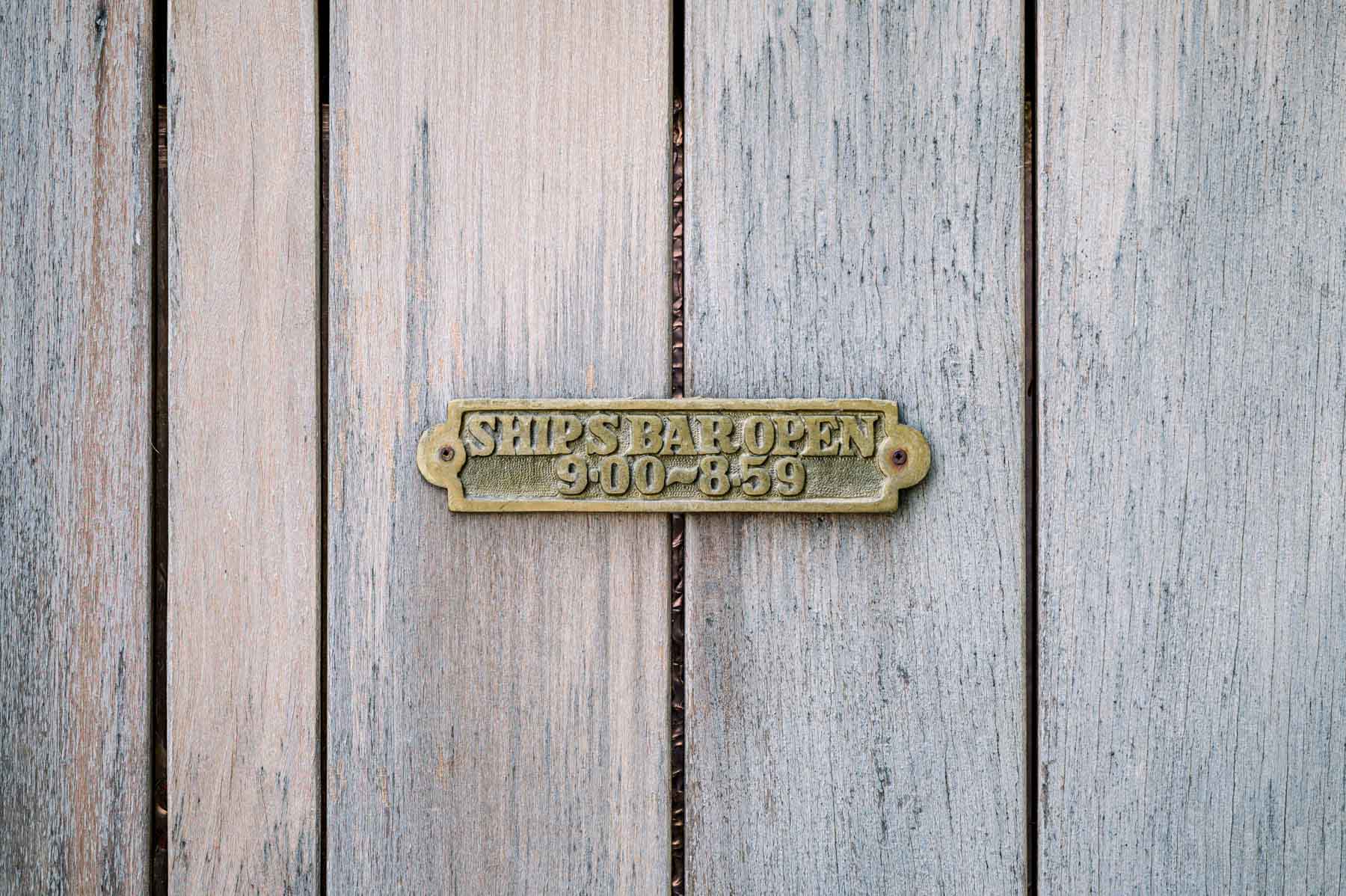 Brass plaque screwed onto the wooden planks of the wedding barge