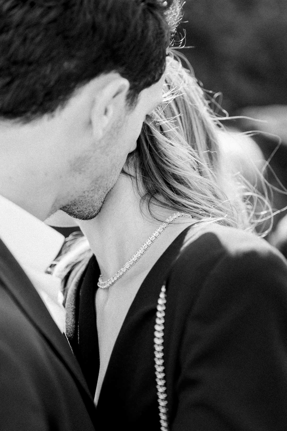The couple embracing cheek to cheek on the barge, in black and white