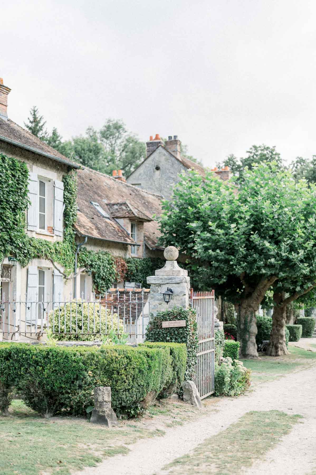 Ivy-clad stone houses and clipped hedges in the Moulin de Launoy hamlet