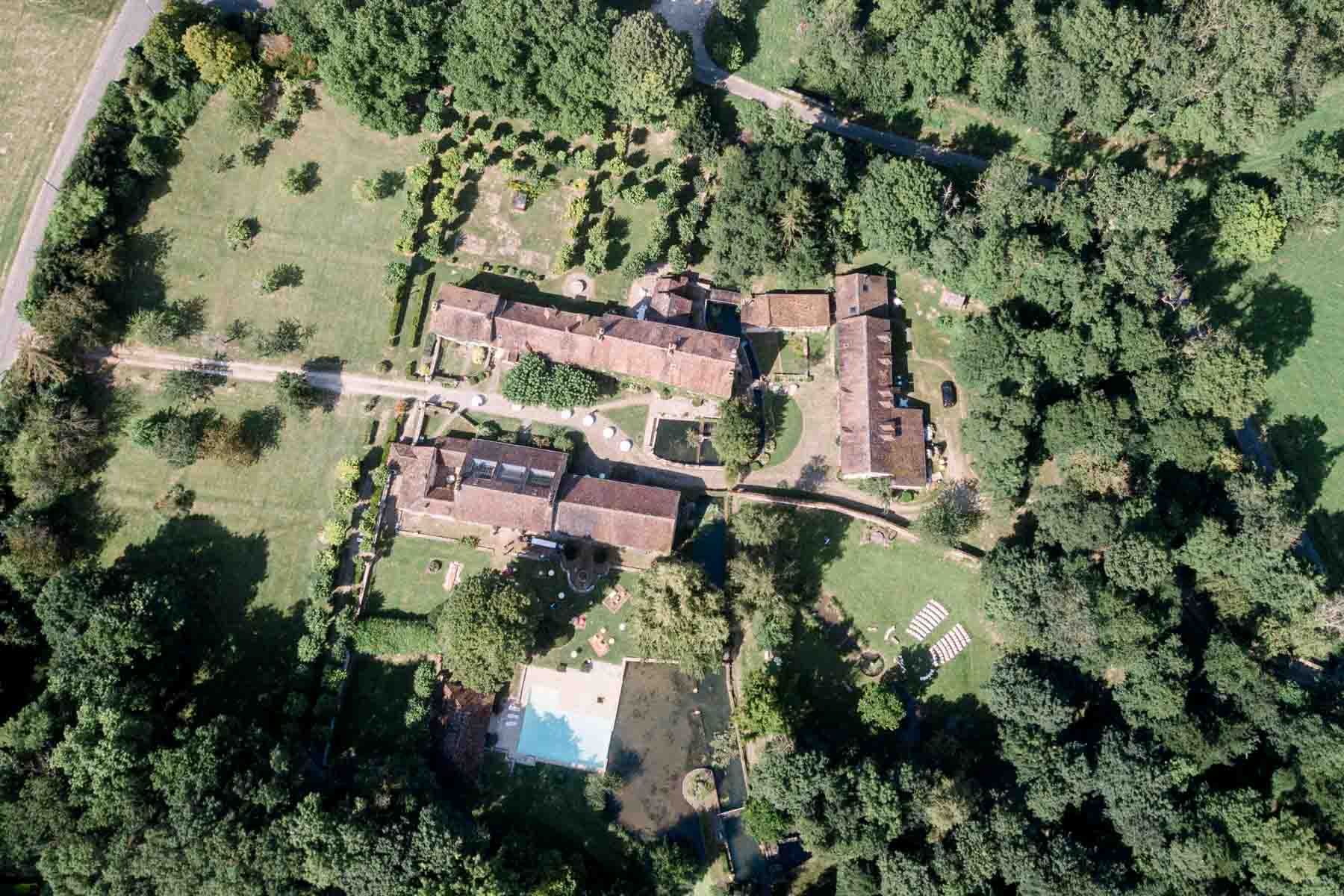 Aerial view of the Moulin de Launoy estate surrounded by woodland