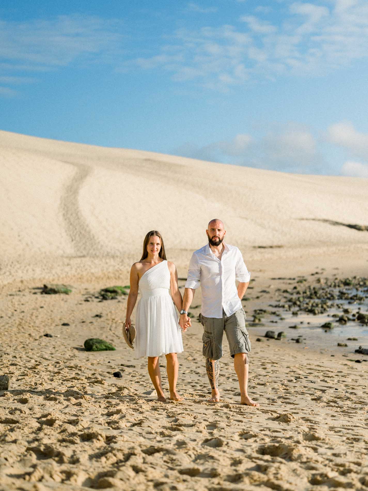 Couple walking on the beach at the foot of the Dune du Pilat