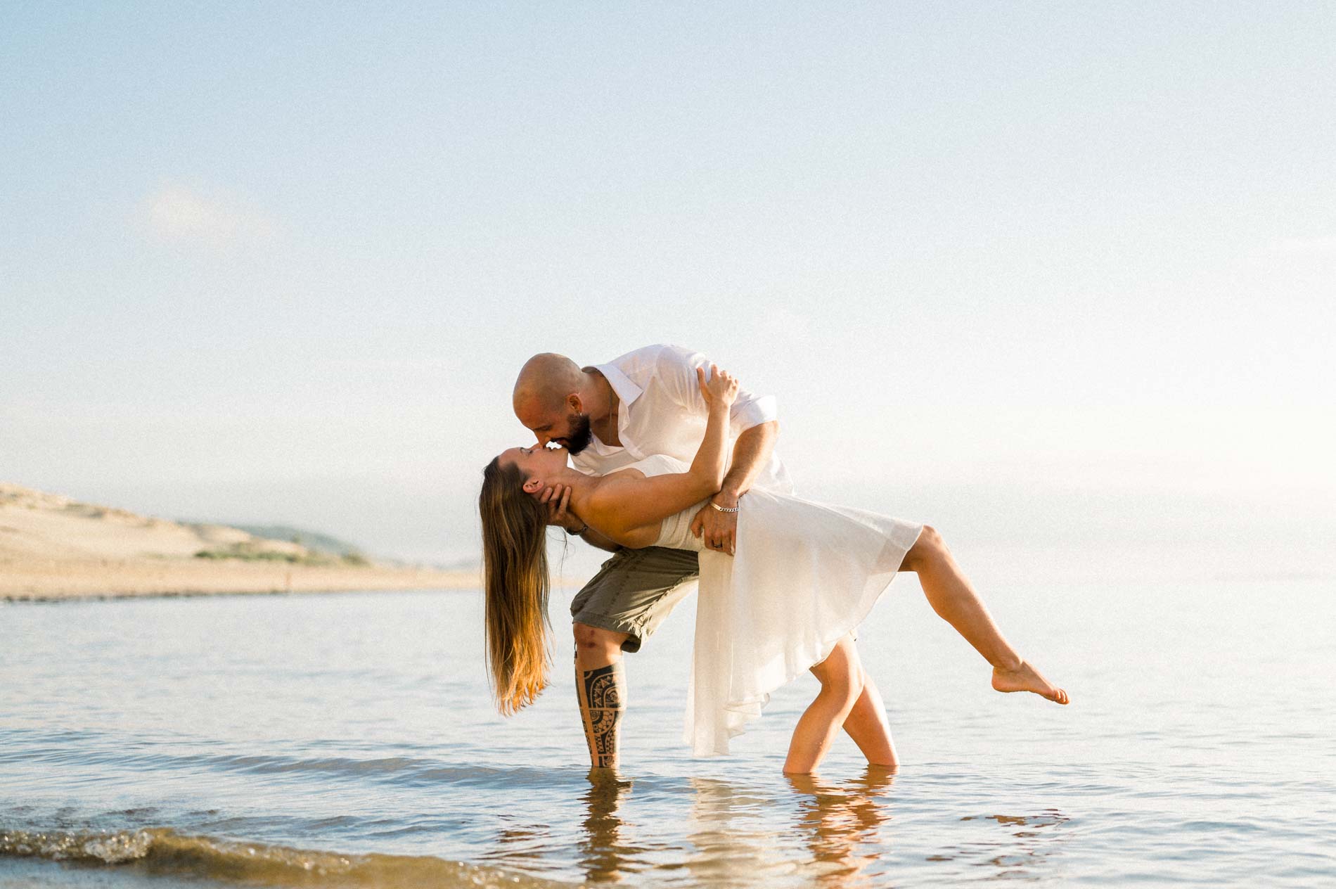 Couple dancing in the shallows near the Dune du Pilat