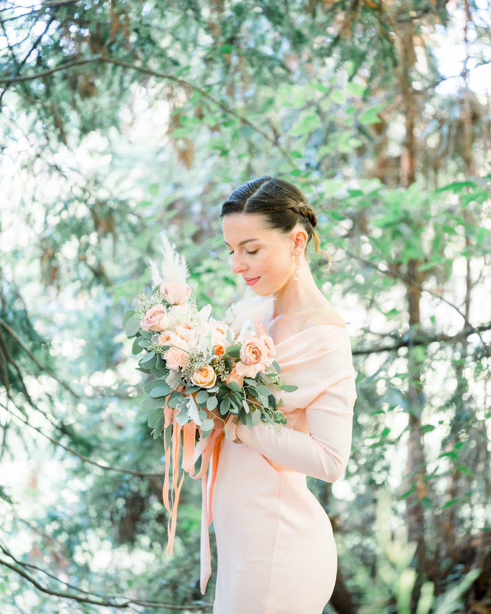Profile portrait in a pink dress with a bouquet of roses and orange ribbons